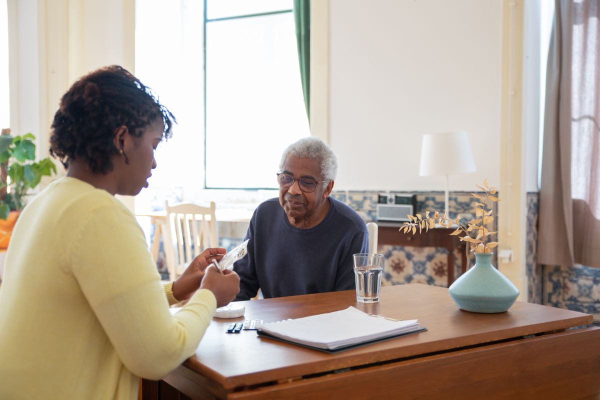 Caregiver assisting with medication reminders